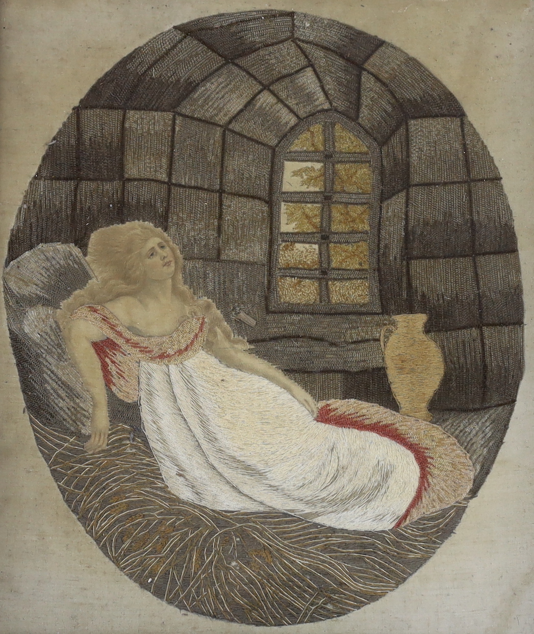 A framed Georgian wool and silk picture of a recumbent lady